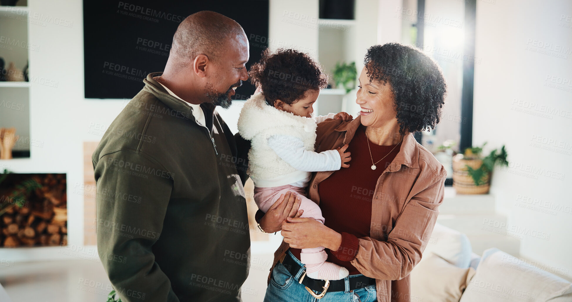 Buy stock photo Happy, family and parents with baby in home, together and bonding with girl on weekend or connection. African people, mom and dad with daughter, laughing and smile for child development in lounge