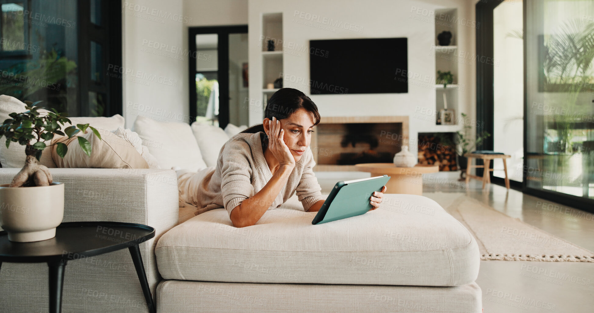 Buy stock photo Tablet, relax and woman on sofa in home for watching movie, film or series with subscription. Online, weekend and female person on digital technology for streaming show on app in living room at house