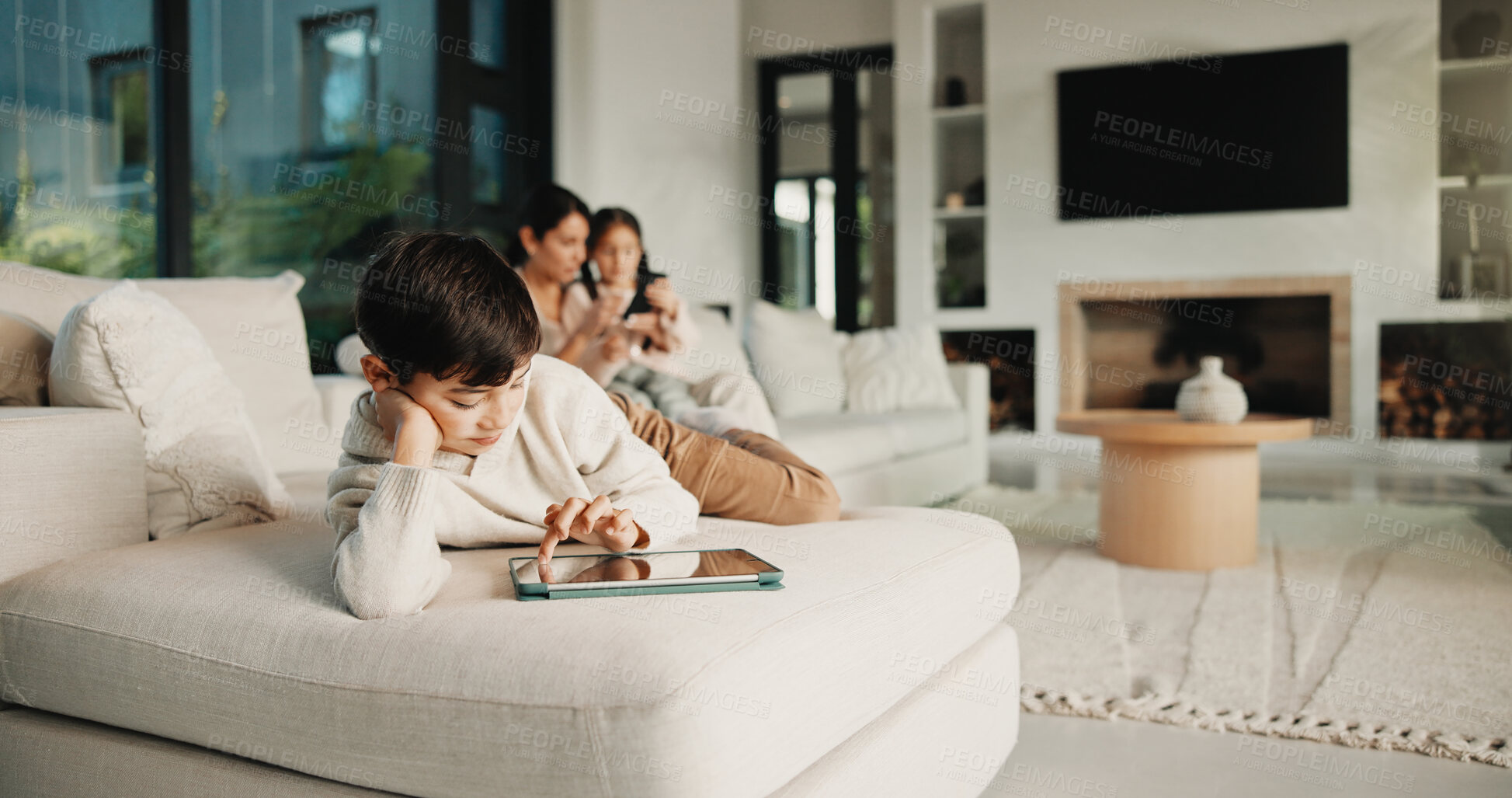Buy stock photo Family, relax and boy on tablet in living room for movies, streaming or internet show for entertainment. Parents, child and digital tech for social media, play and app in home for weekend together