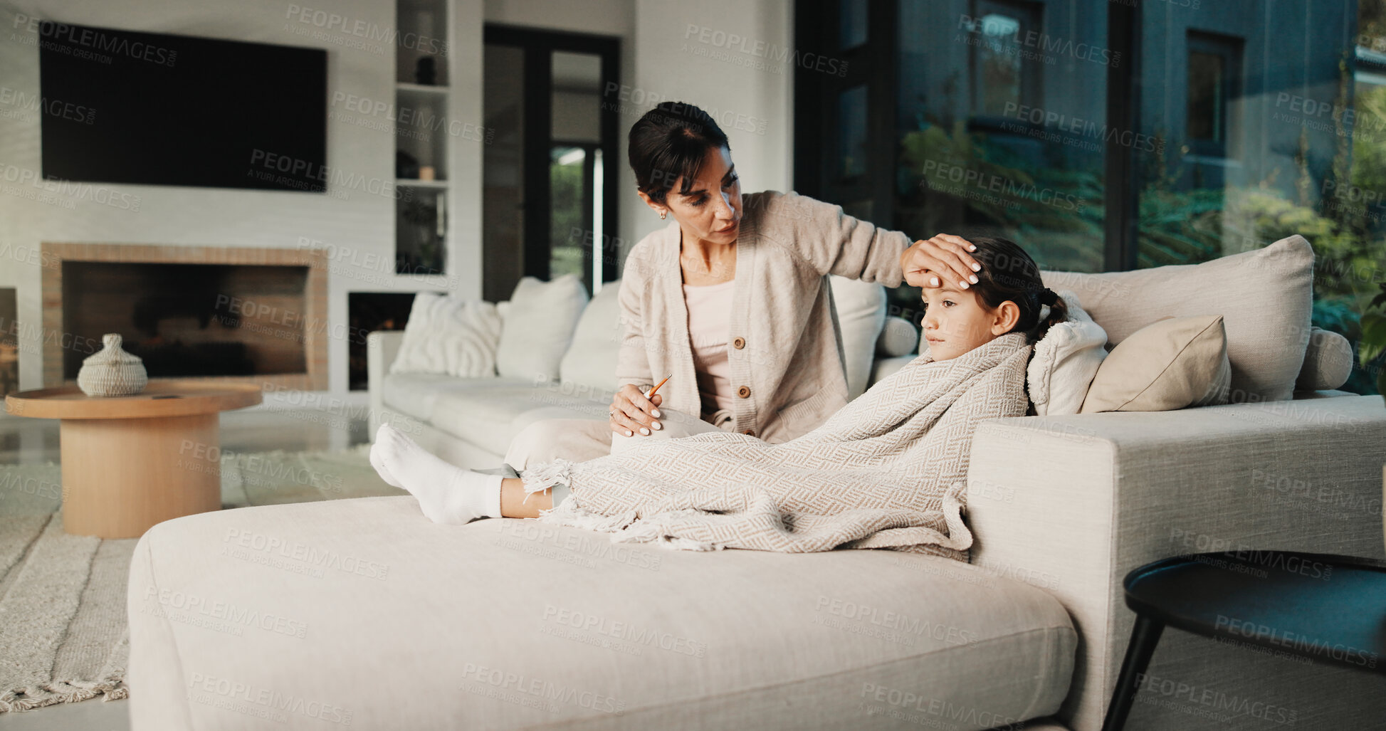 Buy stock photo Sick child, care and mother in living room to check temperature, love and recovery support. Mom, disease and girl in house with cold, virus infection or help with fever for health risk on sofa