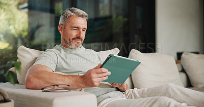 Buy stock photo Streaming, relax or man in house with tablet, movie binge and video watching on digital app. Smile, comfy or mature person in lounge with tech, series subscription or search on entertainment platform