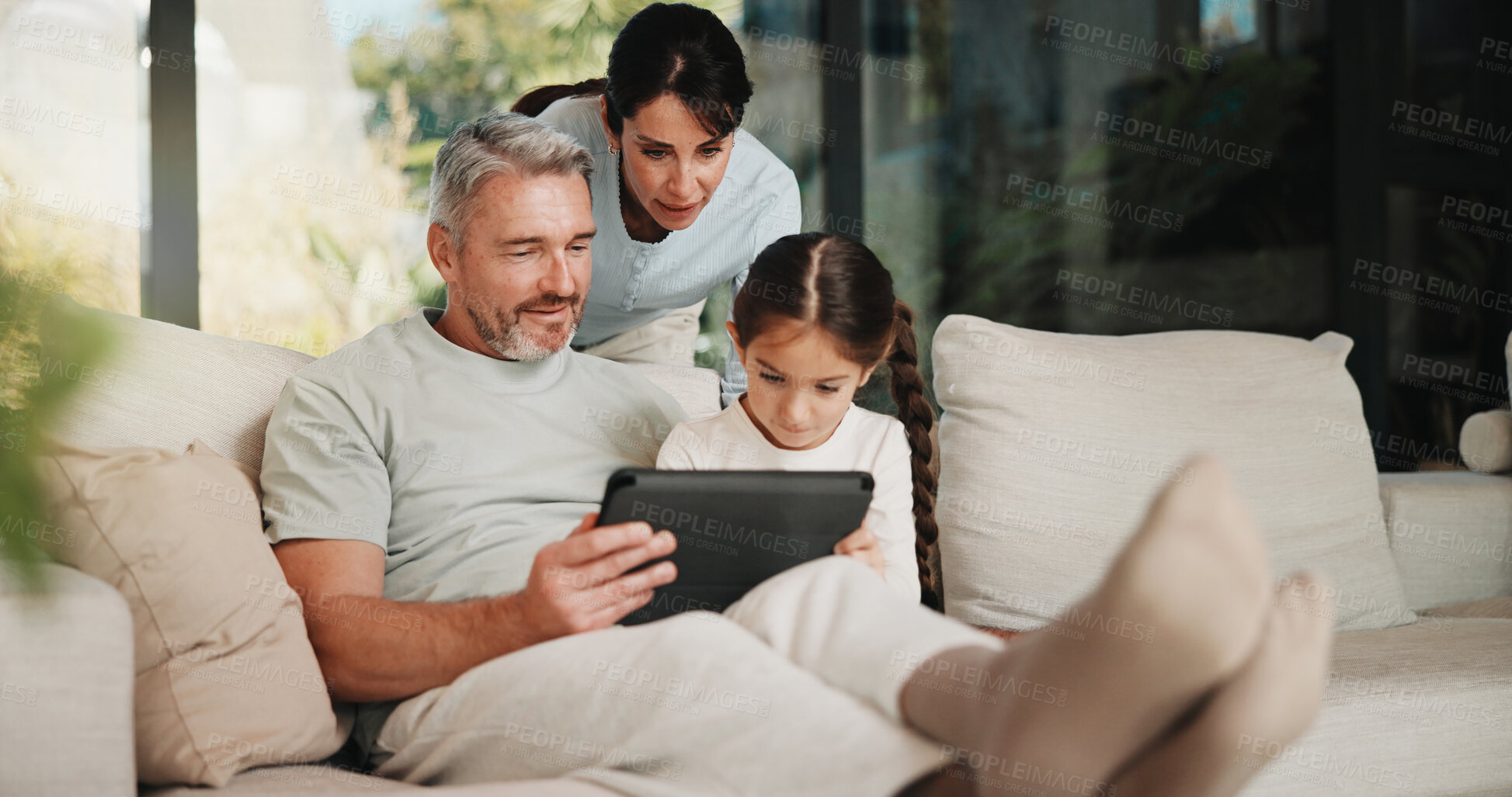 Buy stock photo Family, relax and man on tablet in living room for movies, streaming or internet show for entertainment. Parents, girl and digital tech for social media, game and app in home for weekend together