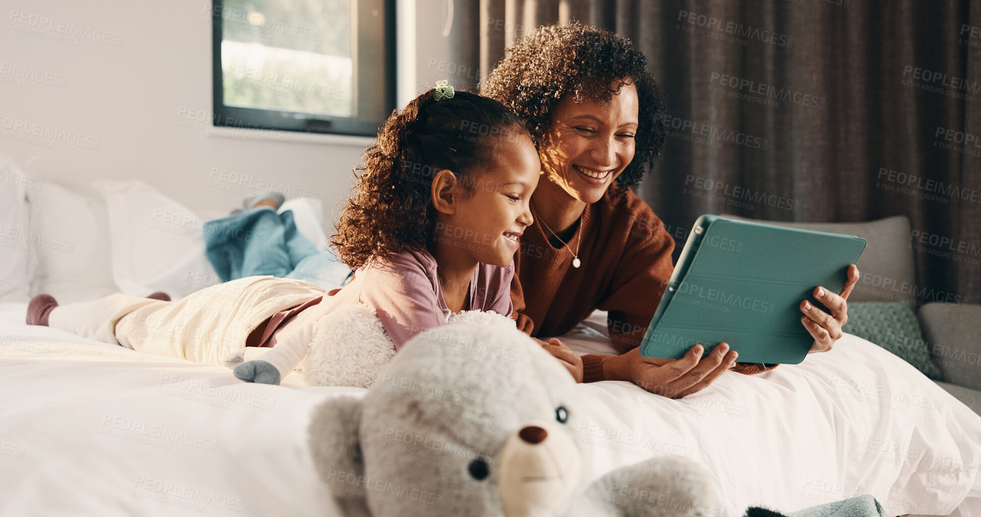 Buy stock photo Tablet, child and happy mother in bed for relax, watch movie and bonding together with parent. Technology, mom and girl in bedroom at family home for streaming cartoon, show and smile with daughter