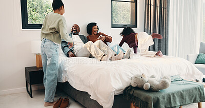 Buy stock photo Parents, laugh and playing with children in bedroom for fun, holiday break and bonding together. Smile, people and kids jump on bed for excitement, weekend activity and parenthood with games at house