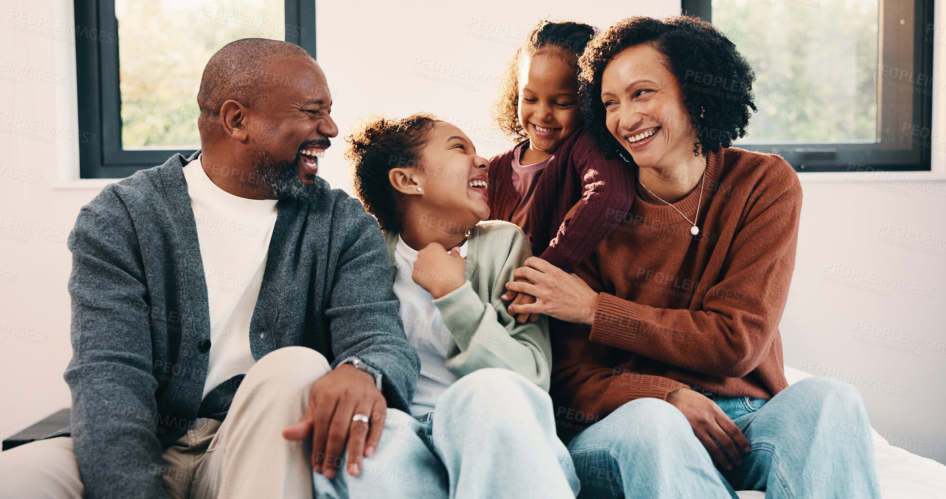 Buy stock photo Parents, play and laughing with kids in bedroom for fun, holiday break and bonding together. Smile, people and tickle children for excitement, weekend activity and parenthood with funny games in home