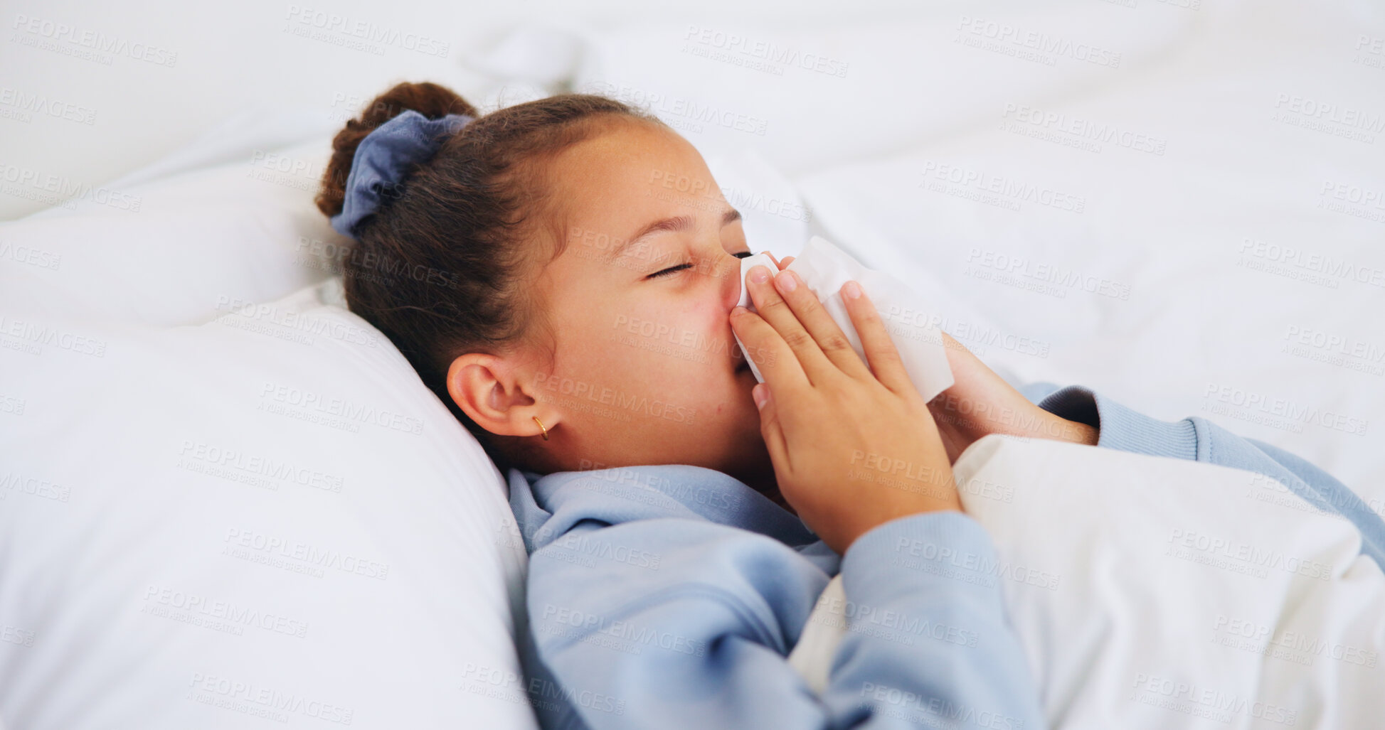 Buy stock photo Sick, child and blowing nose in bed with allergies, congestion and sinus infection in home. Girl, tissue and sneezing in bedroom with influenza, virus symptoms and fatigue with hayfever in house
