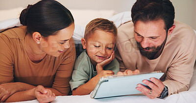 Buy stock photo Love, tablet and parents with child in bedroom to relax together, watch cartoon or online show. Tech, mother and father with boy at family home for bonding, movie and streaming series with happiness