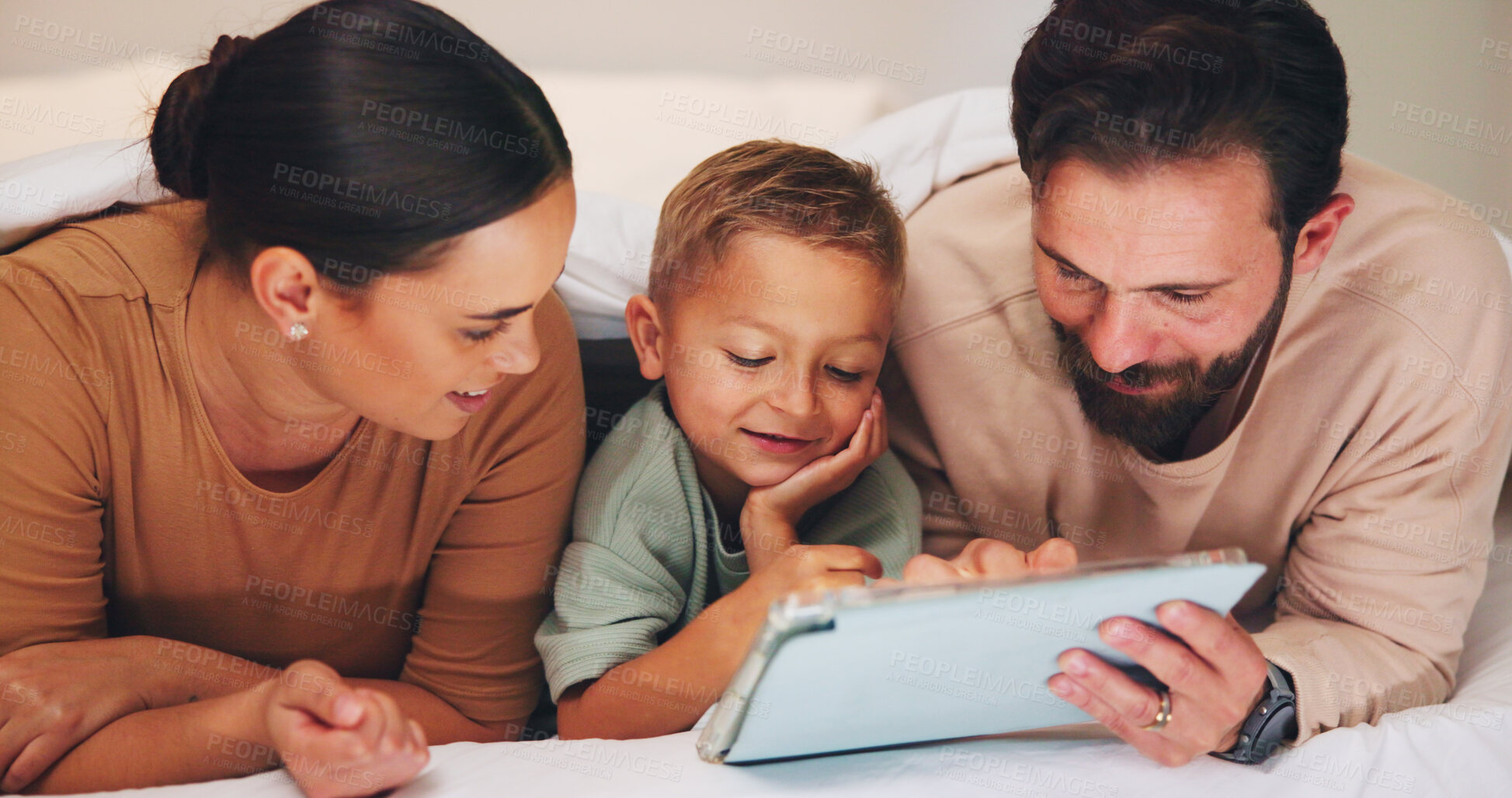 Buy stock photo Love, tablet and parents with child in bedroom to relax together, watch cartoon or online show. Tech, mother and father with boy at family home for bonding, movie and streaming series with happiness