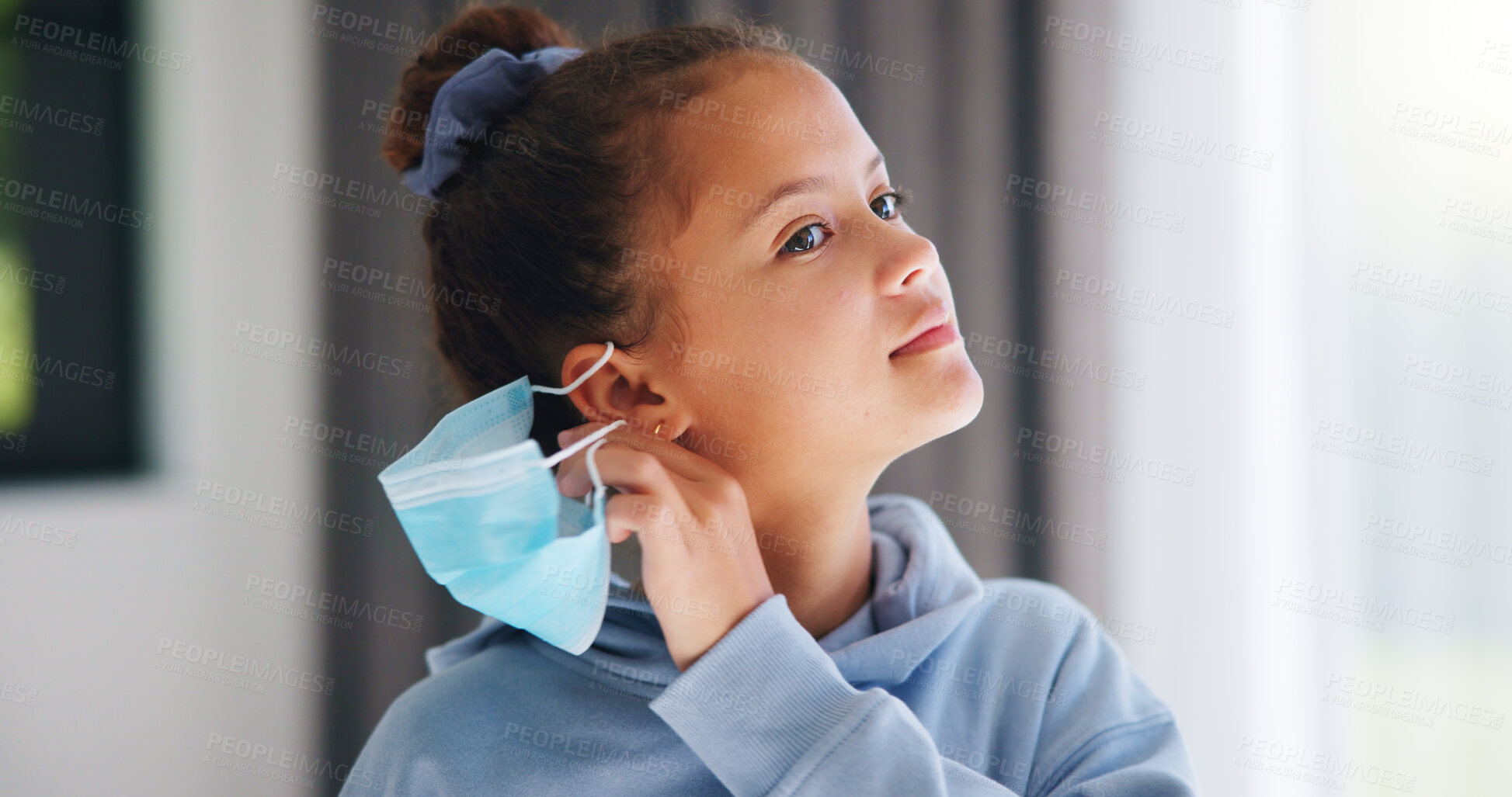Buy stock photo Face mask, healthcare and remove with girl kid in home for infection control, regulations or safety. Compliance, medical and security with child in apartment for protection from bacteria or germs