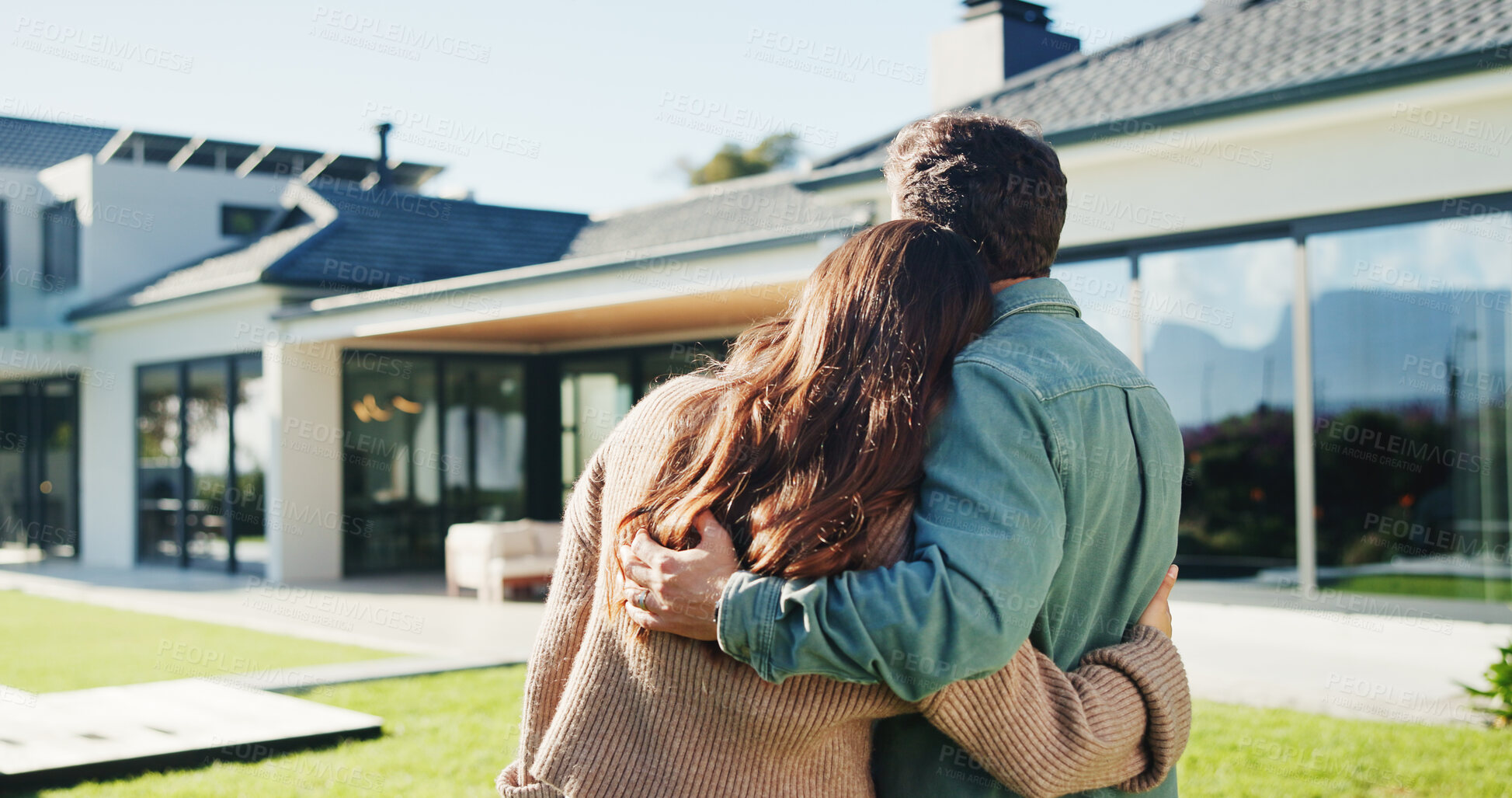 Buy stock photo Back, couple and hug in backyard with new home, bonding together and support for property investment. Married people, outdoor and moving in dream house with embrace, relocation and real estate goals.