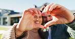 Hands, couple and sign with heart at new house for love, partner support or real estate success. Portrait, smile and people with gesture for thank you, moving in and relocation of property investment
