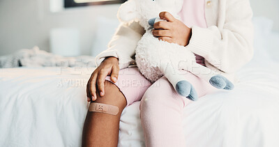 Buy stock photo Plaster, child and hands in house with first aid for wellness, wound protection and toy for comfort. Sad emoji, teddy bear and kid with bandage for injury healing process, health and recovery support