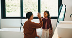 Morning, mother and high five in bathroom with daughter, getting ready or support for child development. Happy, woman and kid in home with grooming routine goals, wellness and celebration for growth.