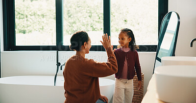 Buy stock photo Morning, mother and high five in bathroom with daughter, getting ready or support for child development. Happy, woman and kid in home with grooming routine goals, wellness and celebration for growth.