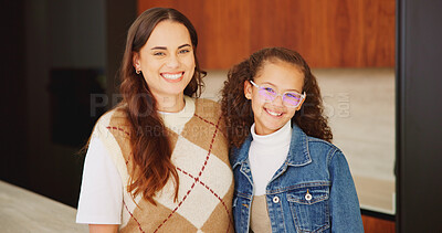 Buy stock photo Mother, daughter and happy for portrait in home with connection, love and care with glasses. Wellness, smile and hug with woman and girl child in family house for safety, security or relax on weekend