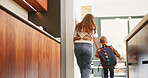 Mom, boy and holding hands with bag in kitchen for support, care or back to school in home. People, mother and ready with child with learning, bonding or backpack with morning routine at family house