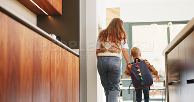 Buy stock photo Mom, boy and holding hands with bag in kitchen for support, care or back to school in home. People, mother and ready with child with learning, bonding or backpack with morning routine at family house