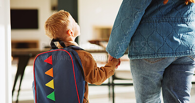 Buy stock photo Mother, child and holding hands in home with backpack, support or getting ready for preschool education. Back, mom and boy in lounge with bag, leaving and morning routine for learning at ECD academy.