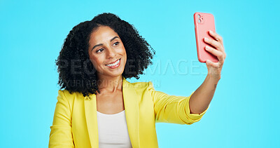 Buy stock photo Selfie, happy and woman in studio with smile for social media, online post and memory on mobile app. Influencer, content creator and person with photo for profile picture, update and blue background