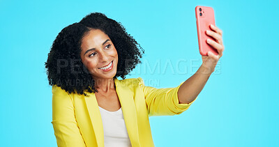 Buy stock photo Selfie, happy and woman in studio for social media, online post and memory on mobile app. Influencer, content creator and person smile for photo with profile picture, update and blue background
