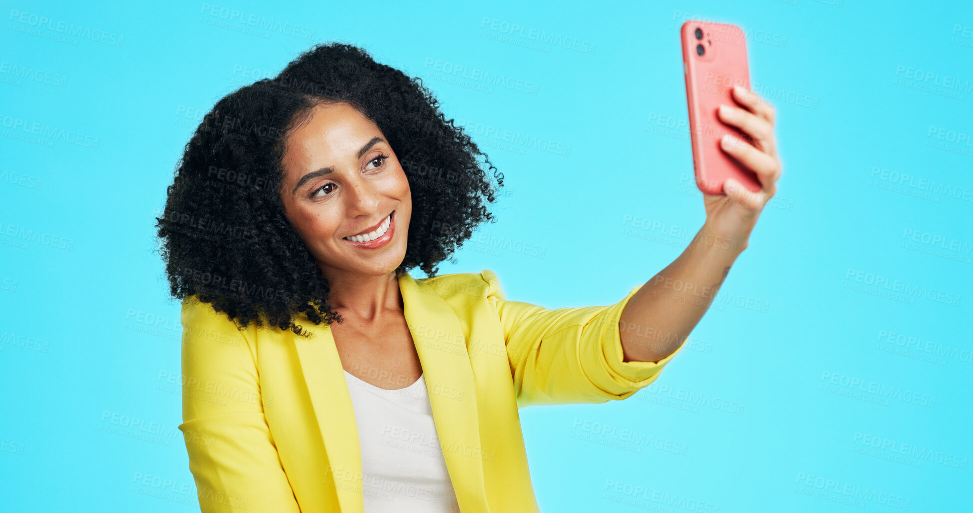 Buy stock photo Selfie, happy and woman in studio for social media, online post and memory on mobile app. Influencer, content creator and person smile for photo with profile picture, update and blue background