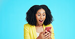 Surprise, phone and happy woman in studio with shock, mobile notification or app promotion for discount. Business person, OMG and wow with tech for announcement and excited on blue background