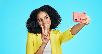 Buy stock photo Smile, peace sign and selfie of woman in studio for social media, profile picture or post. Content creator, v hand emoji and female person with happy memory for influencer update on blue background