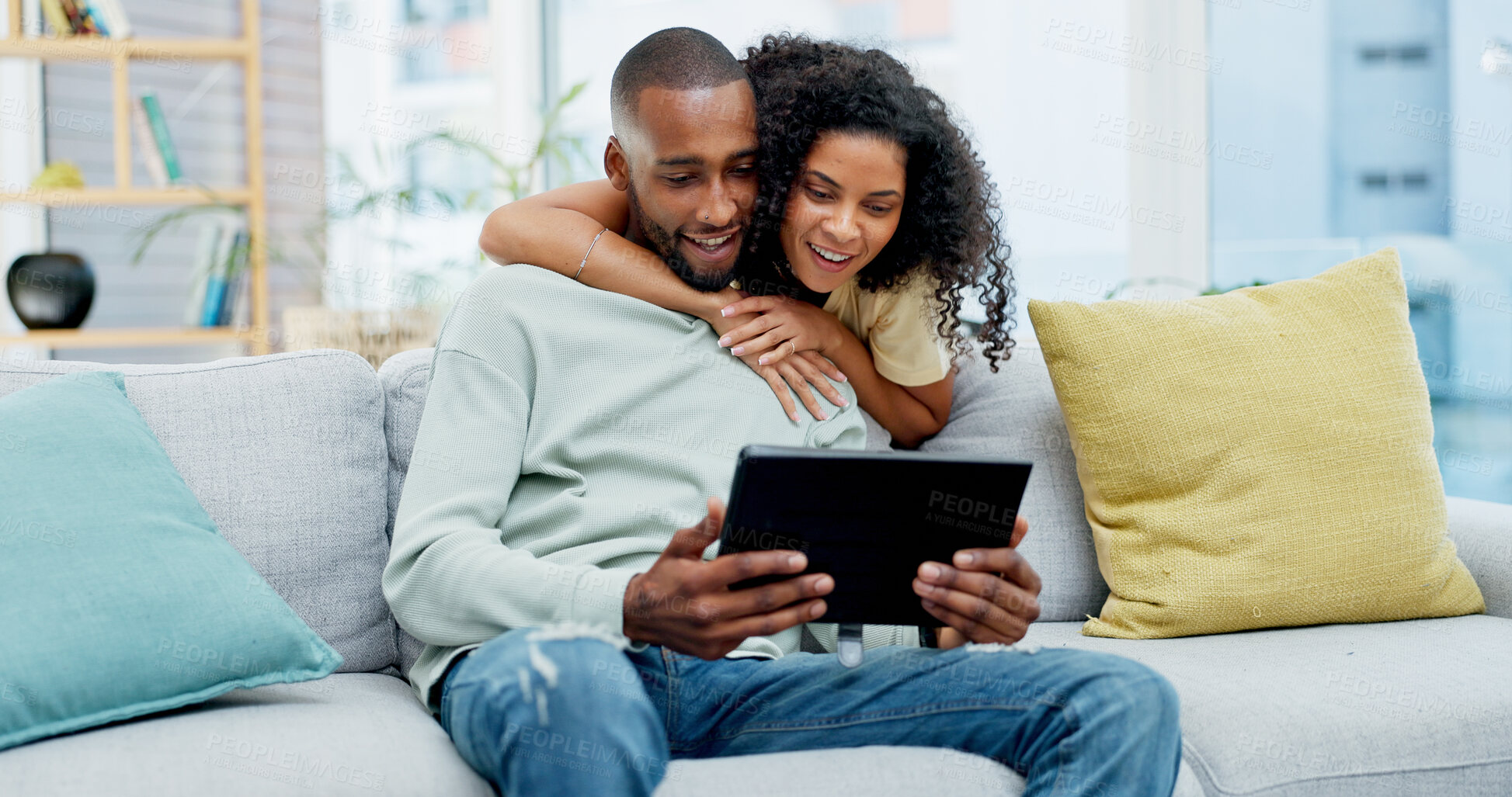Buy stock photo Hug, couple and happy with tablet on sofa for streaming series, social media video and bonding. Love, african people and smile with tech in home for reading online post, relationship or weekend break