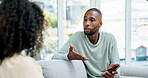 Talking, breakup and couple on sofa in home with communication, conversation or toxic marriage. Upset, conflict and man with woman in living room for disagreement in relationship with stress in house