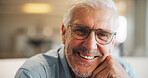Senior, man and happy portrait in home for comfortable retirement, peaceful morning and wellness. Pensioner, elderly person and relax in living room for weekend break, positive attitude and glasses