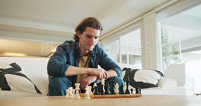 Buy stock photo Man, chess and game on couch with strategy, solution or problem solving in contest in living room. Male person, boardgame and idea with competition for thinking, knowledge or challenge in home