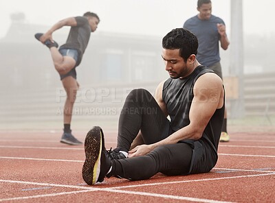 Buy stock photo Sports, track and man getting ready with race, workout or training for outdoor exercise and performance. Athlete, people or runner on ground with cardio, warm up or fitness for competition or running