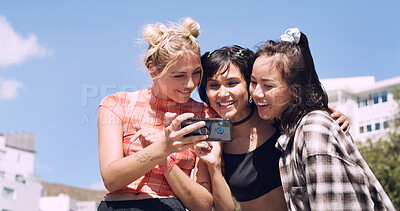 Buy stock photo Phone, happy and women friends in city with social media, contact or memory for weekend. Excited, bonding and group with online post, internet or chat outdoor for summer hangout, vacation or holiday