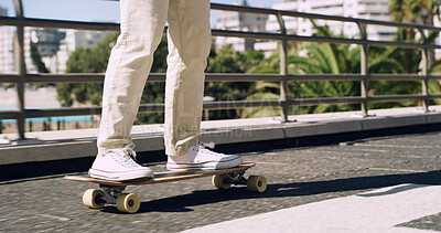 Buy stock photo Legs, skateboard and person in city for practice, balance and extreme sports on ground. Sneakers, feet and skateboarder at skatepark for weekend activity, travel and urban hobby with outdoor road
