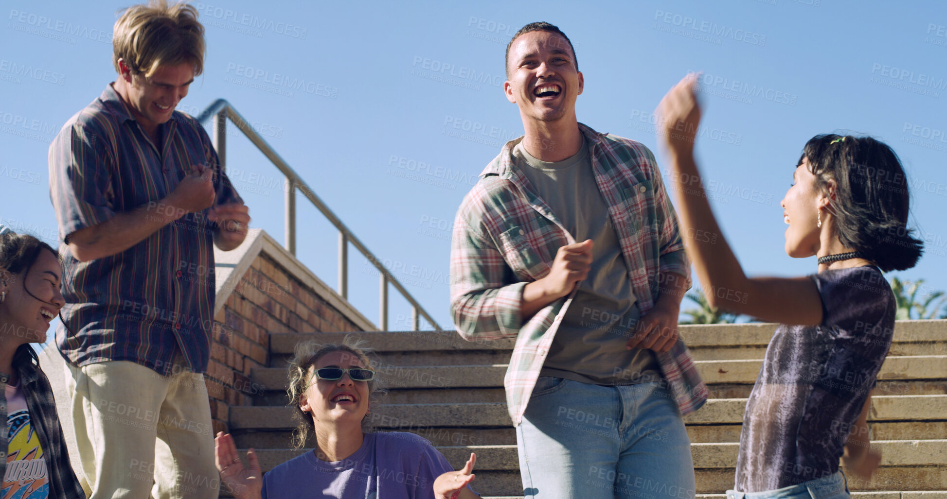 Buy stock photo Dance, laughing and friends in city with excited, fun and happy hangout for weekend. Singing, celebration and group of people chilling on stairs for bonding, gathering and enjoying holiday or break