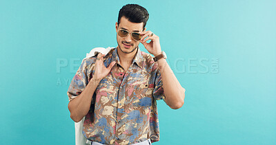 Buy stock photo Fashion, portrait and shades with man in studio for holiday clothing or retro aesthetic. Space, style and sunglasses with person on blue background for summer travel or vacation apparel and clothes