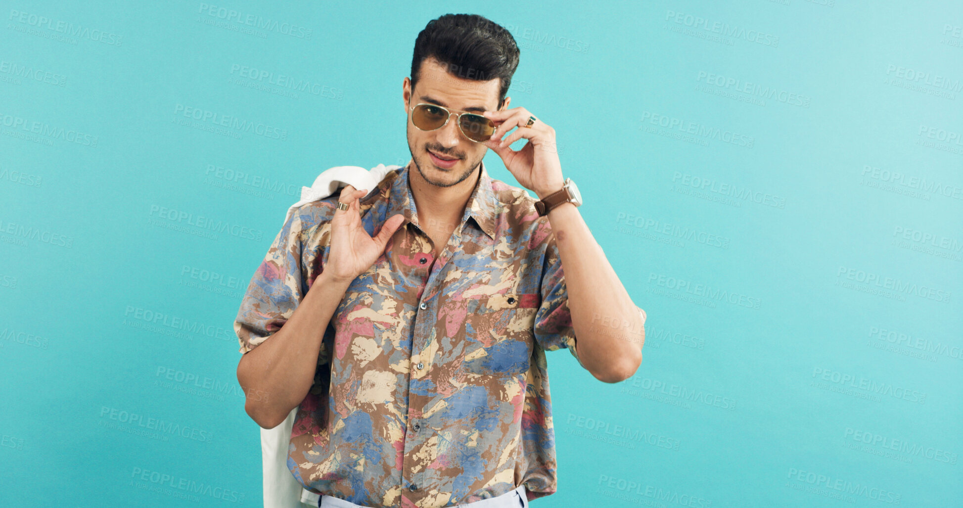Buy stock photo Fashion, portrait and shades with man in studio for holiday clothing or retro aesthetic. Space, style and sunglasses with person on blue background for summer travel or vacation apparel and clothes