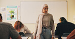 Teacher, classroom and muslim woman with exam, test or school for life science subject. Knowledge, education and educator with teaching assessment, curriculum support and study for course quiz