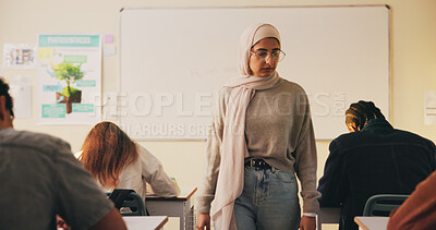 Buy stock photo Teacher, classroom and muslim woman with exam, test or school for life science subject. Knowledge, education and educator with teaching assessment, curriculum support and students for course quiz