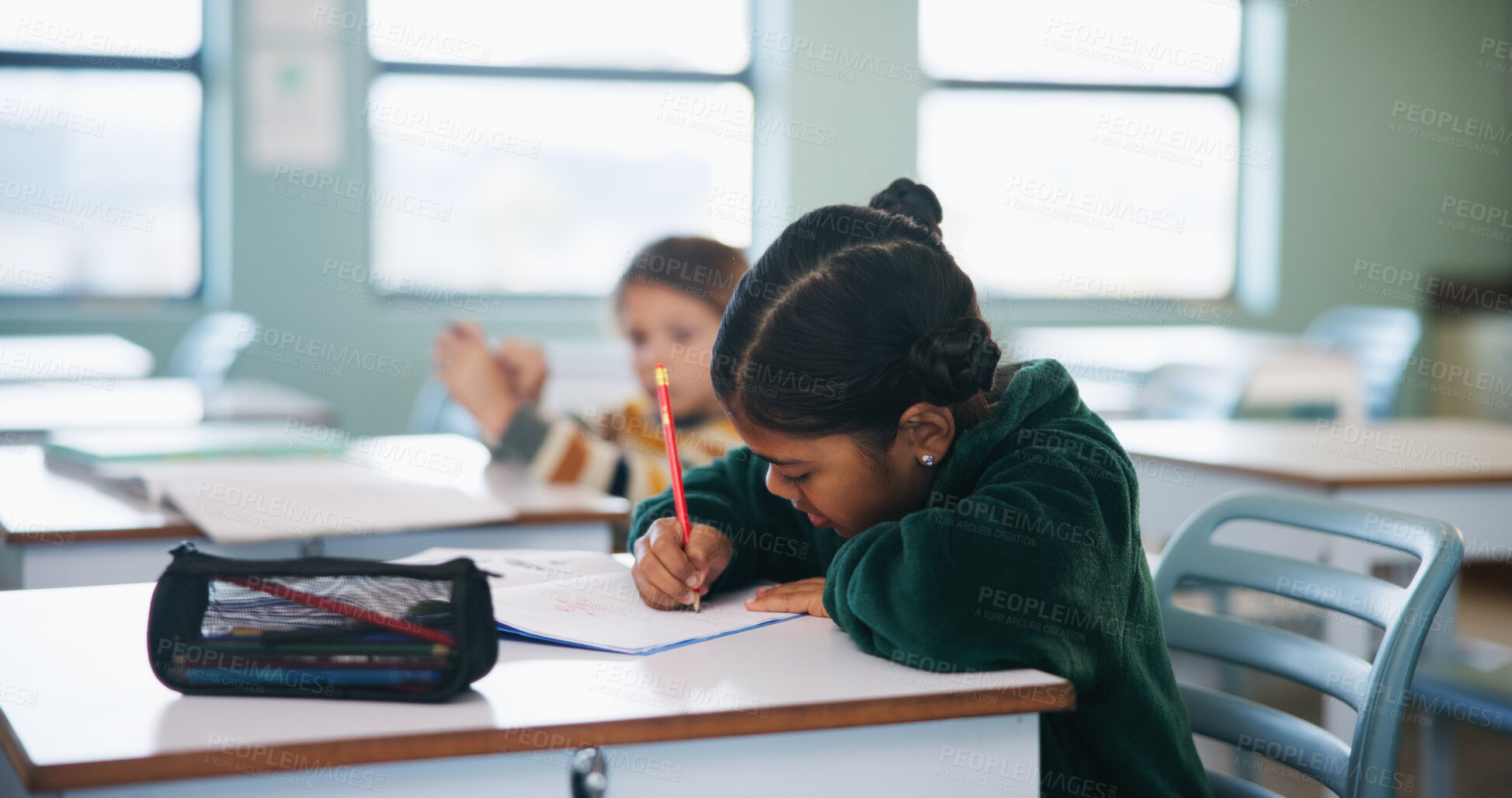 Buy stock photo Writing, assessment and quiz with girl in classroom for test, child development and knowledge. Education, notebook and lesson with student on school campus for learning, curriculum and study course