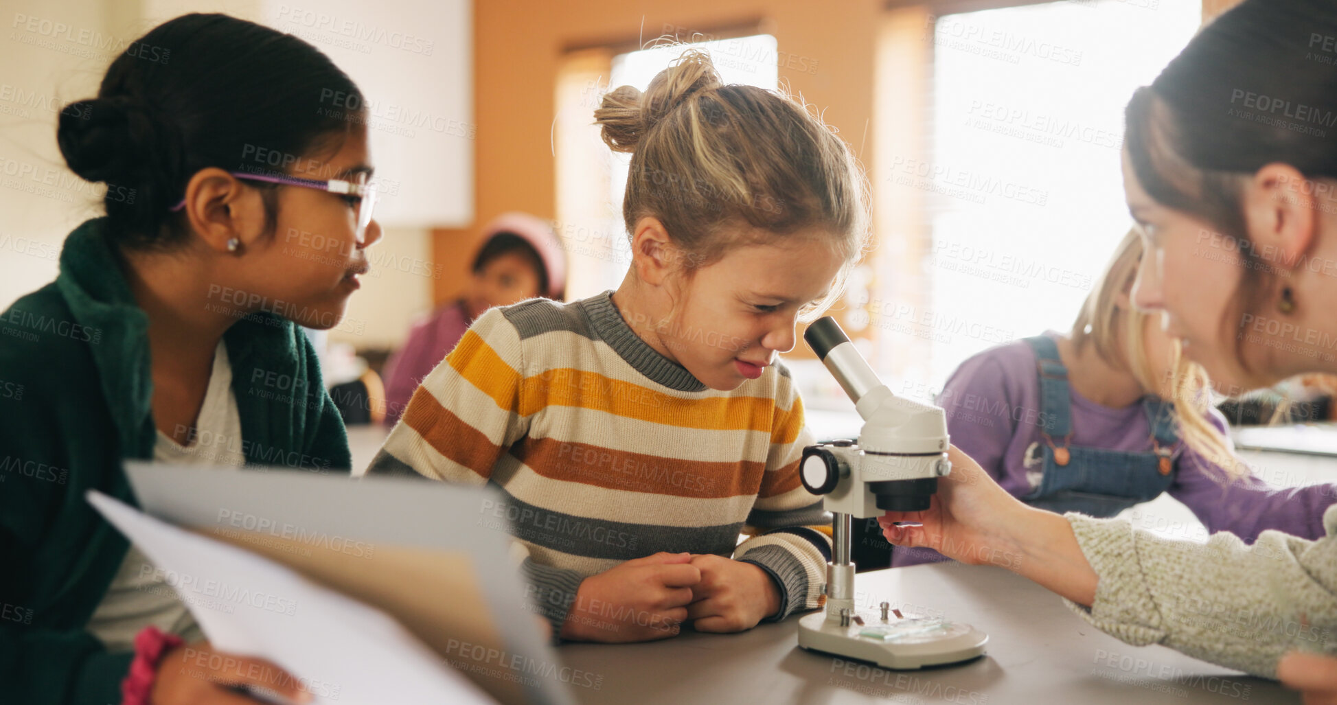Buy stock photo Classroom, teacher and children with microscope for learning, stem education or science lesson. Girl, students and woman teaching with equipment for project, knowledge or biology experiment in school