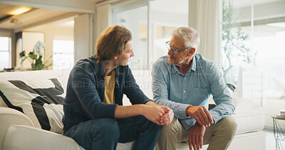Buy stock photo Love, home and senior dad with man for conversation, connection and bonding together on weekend. Elderly father, son or talking on sofa with parent for relax, advice and support in living room