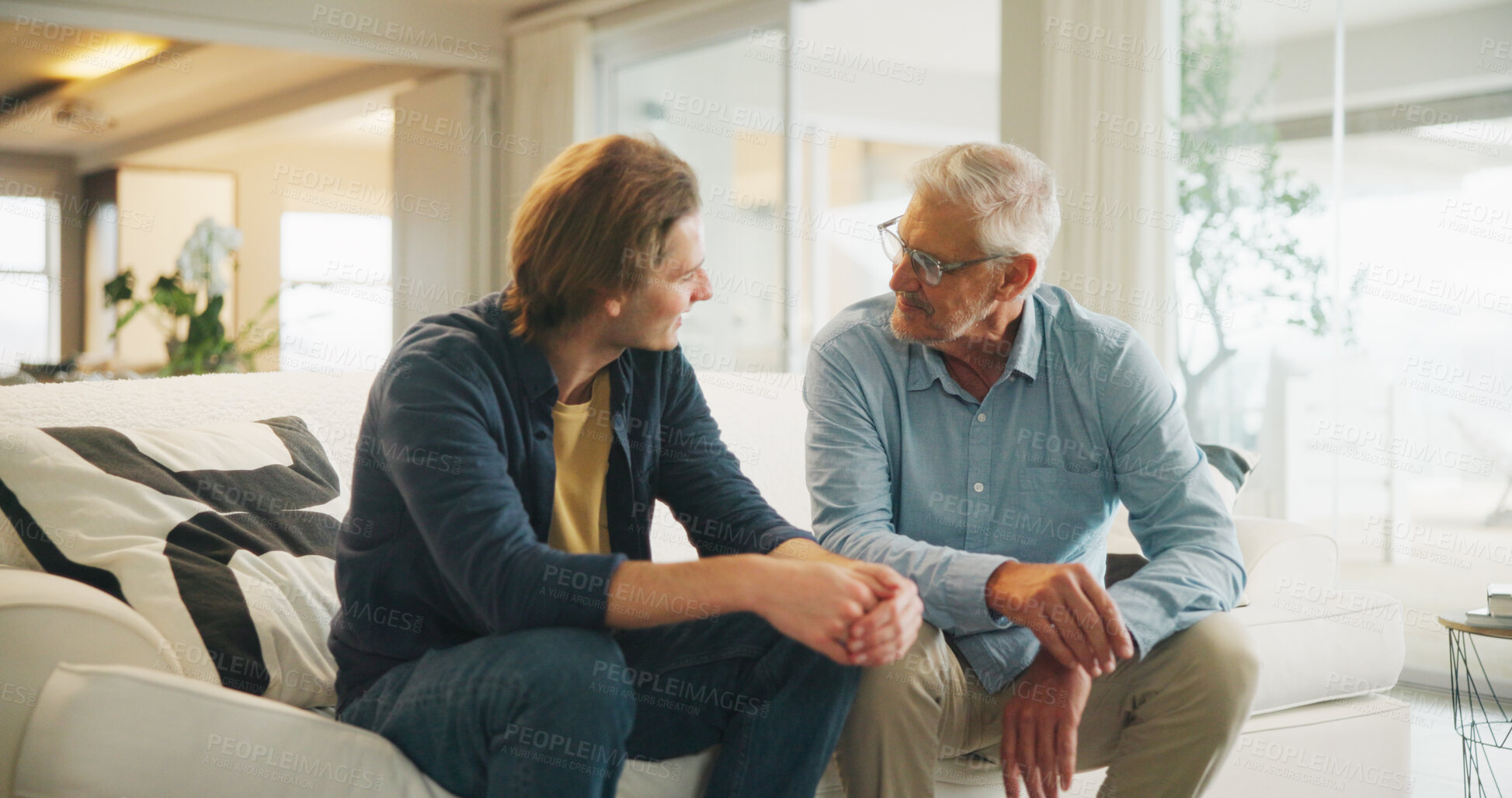 Buy stock photo Love, home and senior dad with man for conversation, connection and bonding together on weekend. Elderly father, son or talking on sofa with parent for relax, advice and support in living room