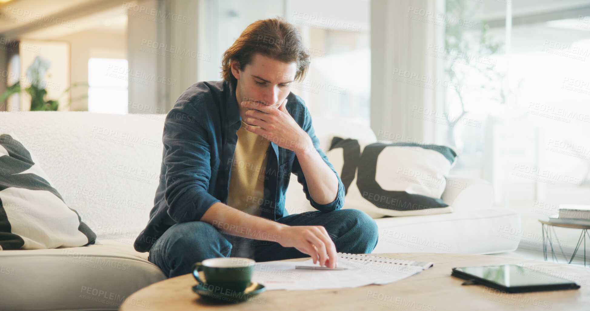 Buy stock photo Man, stress and reading paperwork in home for financial mistake, bankruptcy or mortgage debt. Worried, confused and person on sofa with decision, thinking or planning for documents of bills or loan