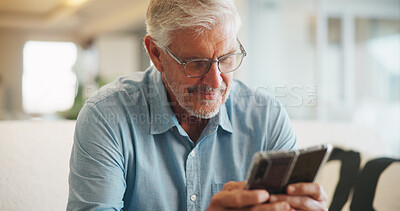 Buy stock photo Old man, online and texting with phone in lounge, reading and communication with contact on website. Elderly person, home and typing message on mobile app, smile and networking on social media