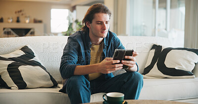 Buy stock photo Reading, man and thinking with phone in home for texting with contact, app and social media. Scroll, person and chat with digital tech in living room for online, typing message or website in lounge