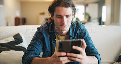 Buy stock photo Reading, man and scroll with phone in home for texting with contact, app and social media. Thinking, person and chat with digital tech in living room for online, typing message or website in lounge