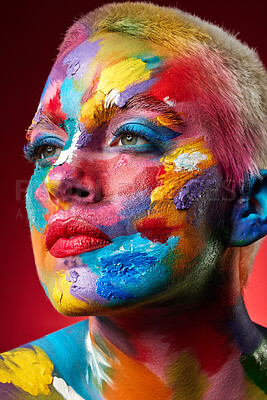 Buy stock photo Woman, face paint and rainbow with beauty in studio for texture, art deco or thinking on red background. Girl, creative makeup and cosmetics with skin, transformation and multicolor with perspective
