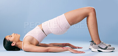 Buy stock photo Fitness, stretching and woman with yoga in studio, mobility routine and wellness practice for posture. Active, pilates and person with bridge pose for endurance exercise, health and blue background
