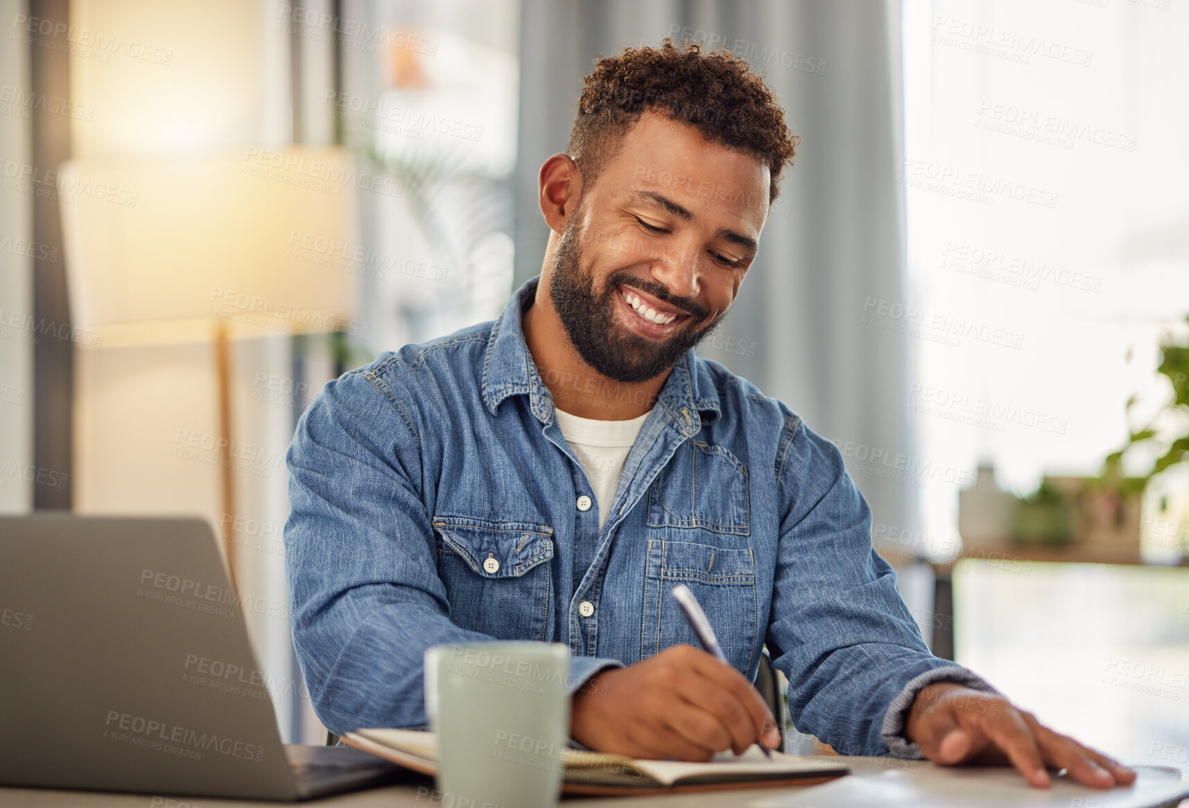 Buy stock photo Man, remote work and writing with notebook at house for research, schedule and story headline. Smile, male freelancer or laptop with notes, copywriting information and planning for article submission